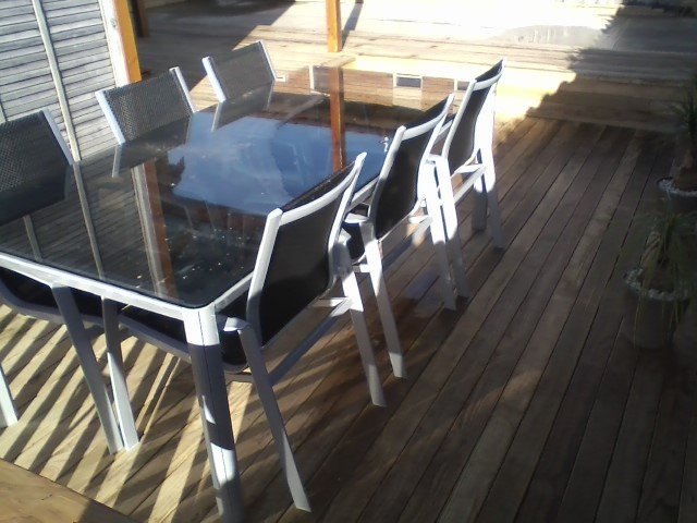 Outdoor dining set on a finished timber deck